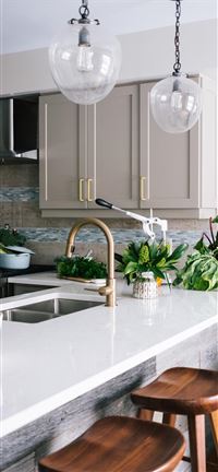 Nicely designed white kitchen with lots of greener... wallpaper