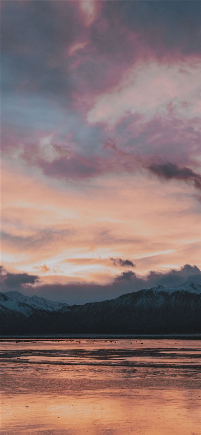 1080x1920 black mountain in front of body of water - sky iPhone SE Wallpaper