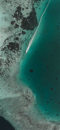 boat leaving white propeller wash in clear green s... wallpaper