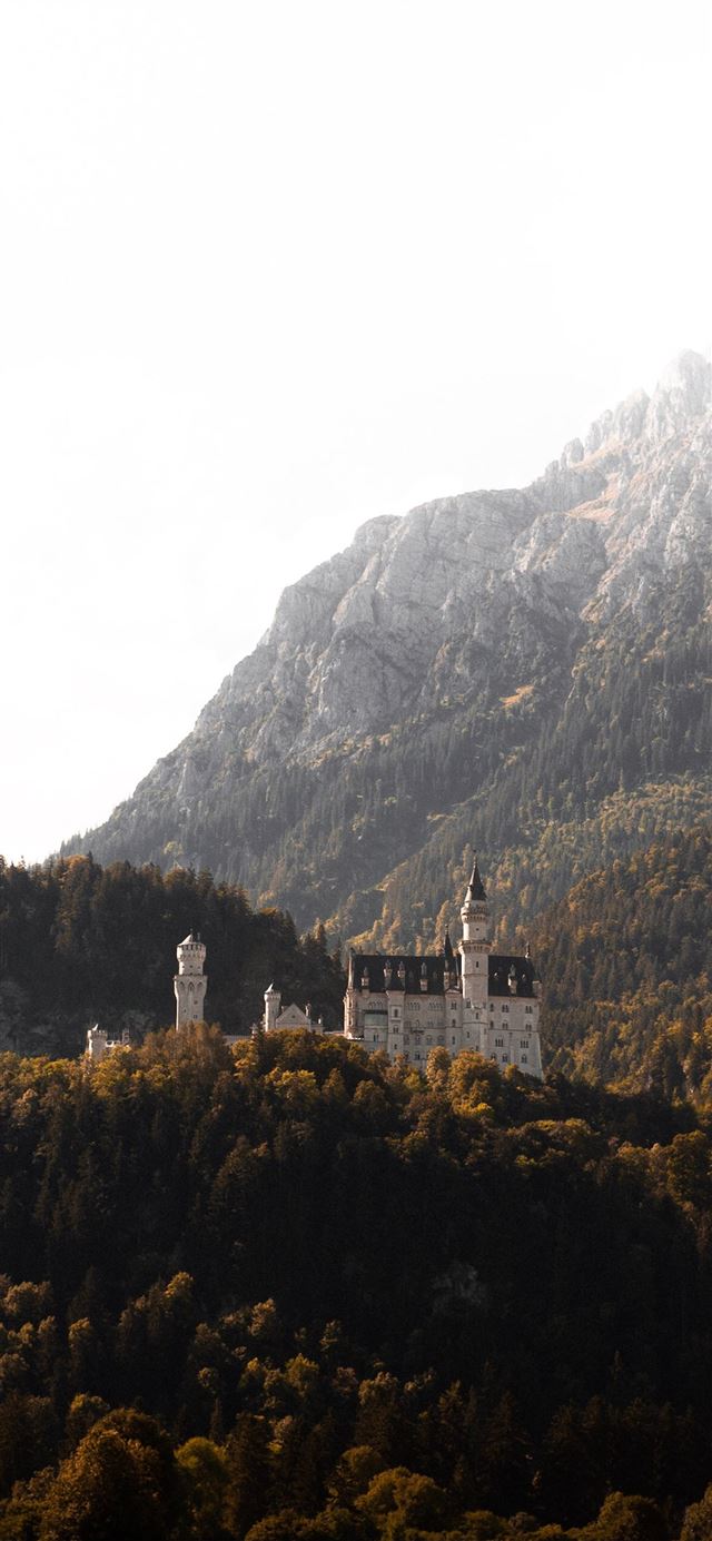 1080x1920 white and brown concrete building beside mountain ... - grey iPhone SE Wallpaper