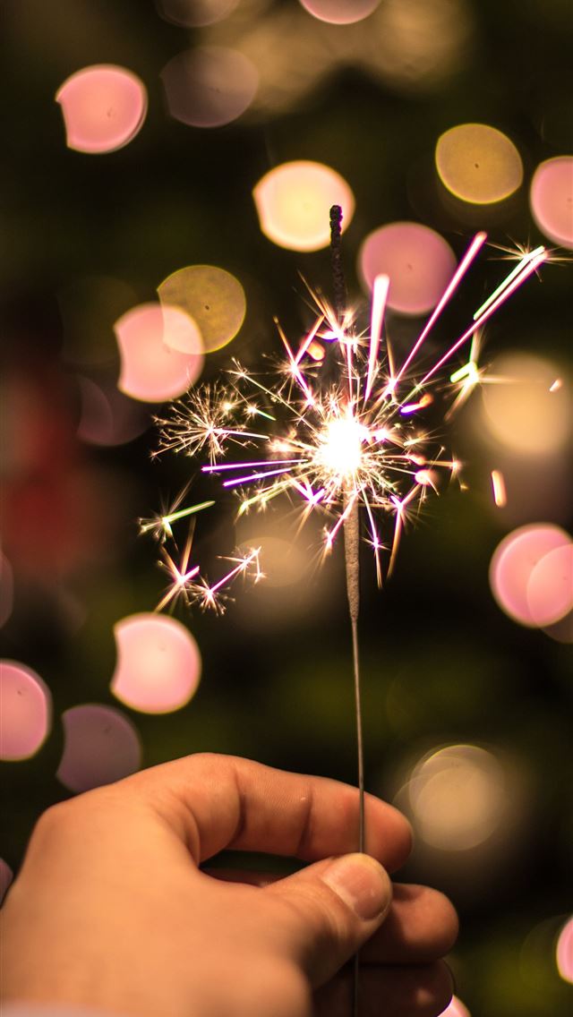 640x1136 bokeh photography of person holding fireworks - holiday iPhone Wallpaper