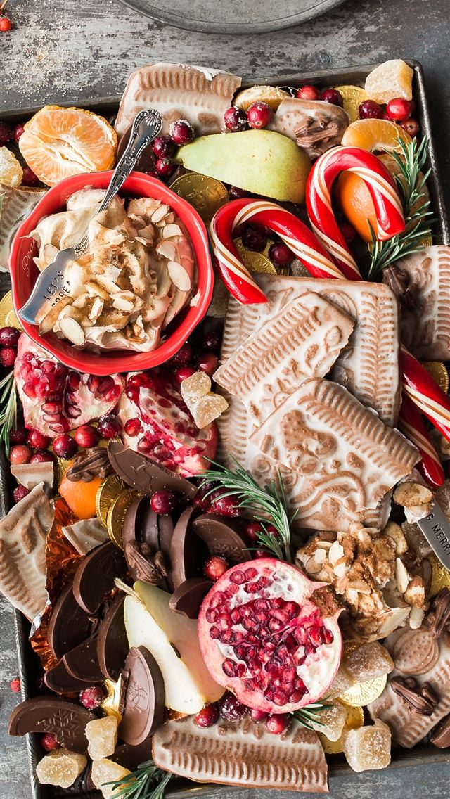 640x1136 variety of sliced fruits cookies and chocolates on... - christmas iPhone Wallpaper