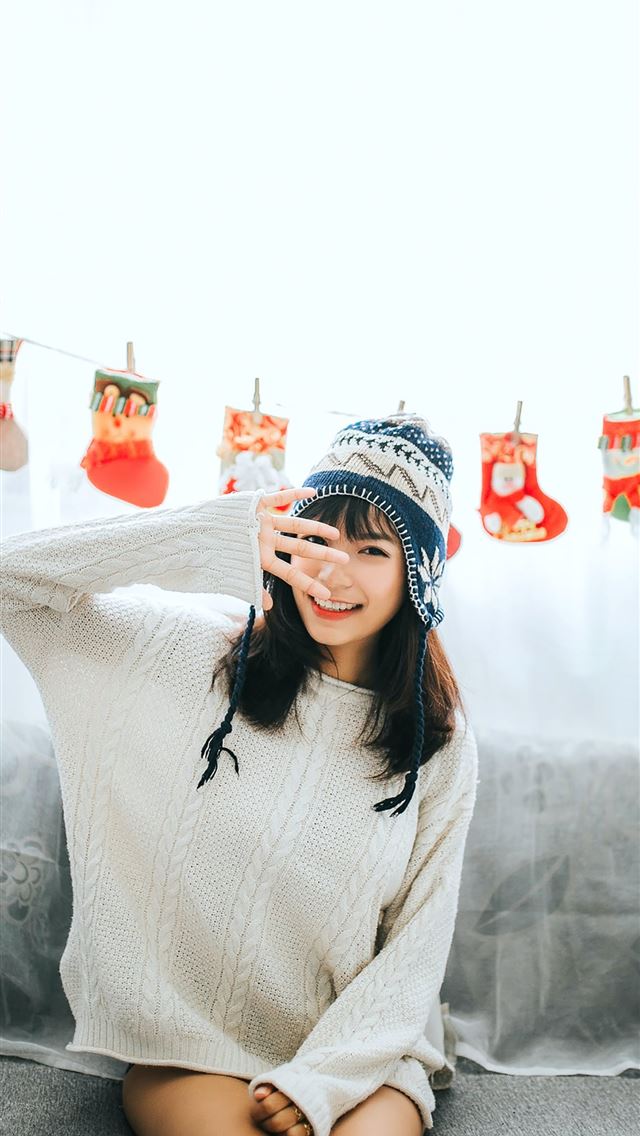 640x1136 woman wearing white sweater sits on gray fabric so... - christmas iPhone Wallpaper