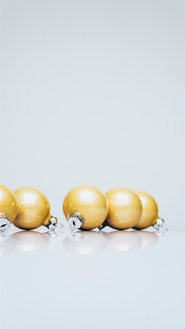 640x1136 six gold Christmas baubles on white wooden surface - food iPhone Wallpaper