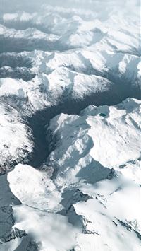 aerial photography of snow covered mountains durin... wallpaper