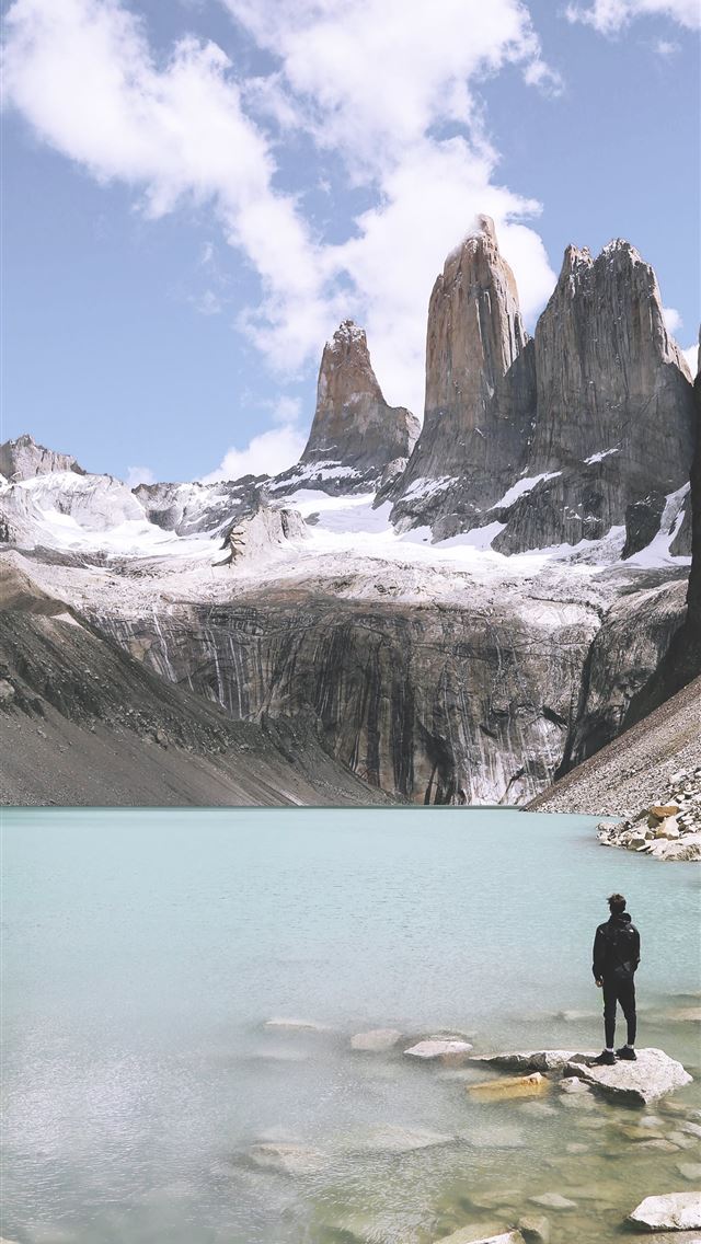 640x1136 man standing above rock beside body of water under... - chile iPhone Wallpaper