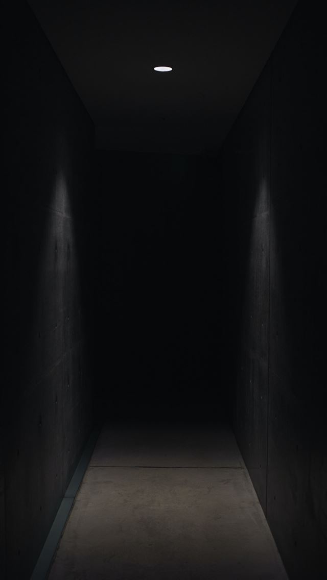 dark pathway lit with small light fixture iPhone wallpaper 