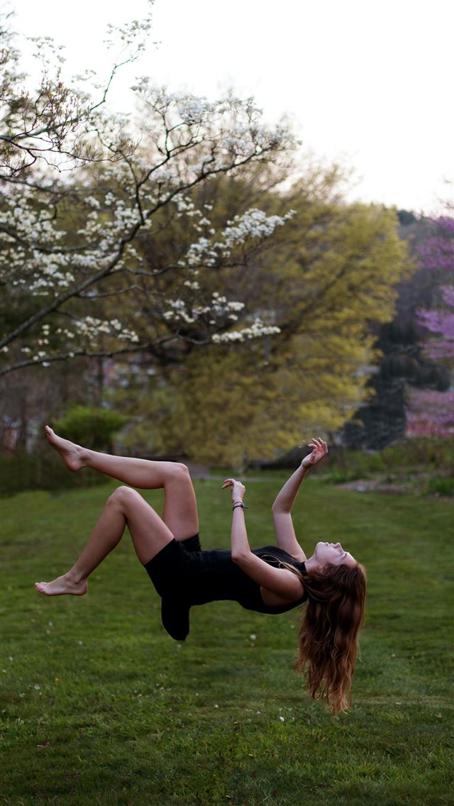 woman back flipping in the garden iPhone wallpaper 