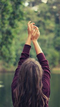 woman raising both of her hands wallpaper