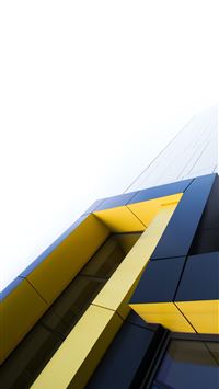 black and yellow building under white clouds wallpaper