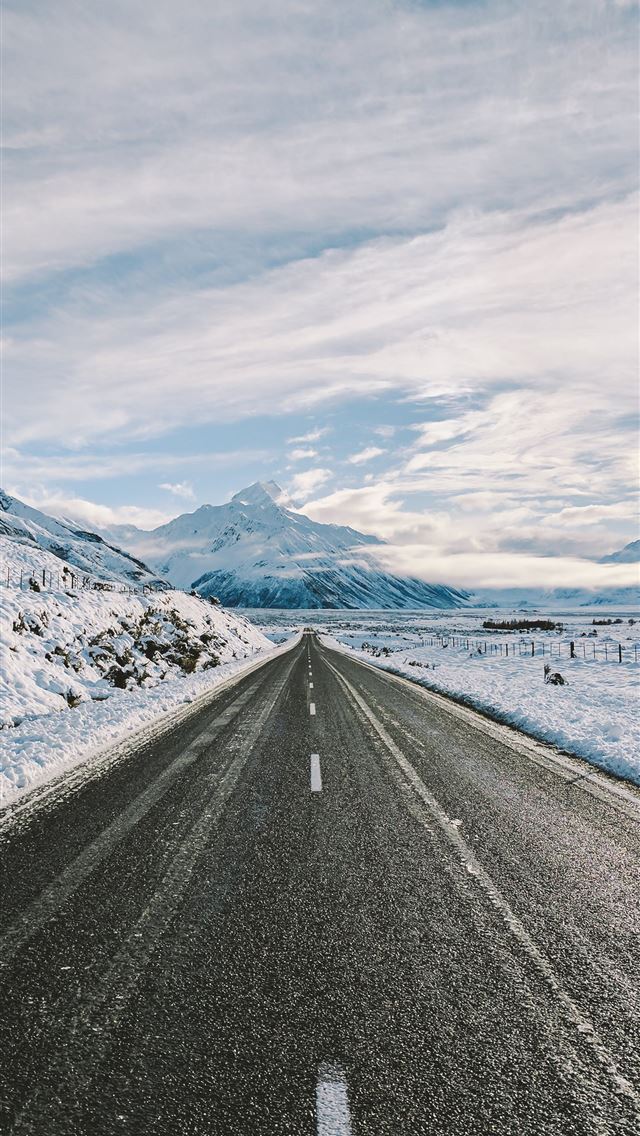 road near mountain covered with snow iPhone wallpaper 