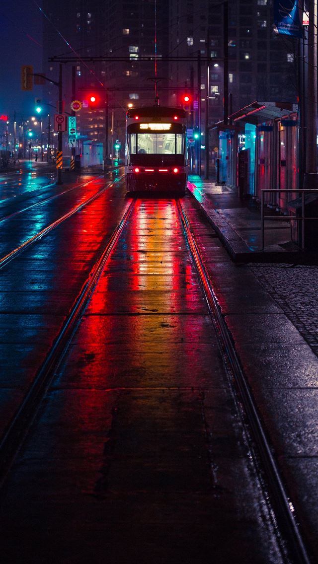 photo of tram beside waiting station during nightt... iPhone wallpaper 