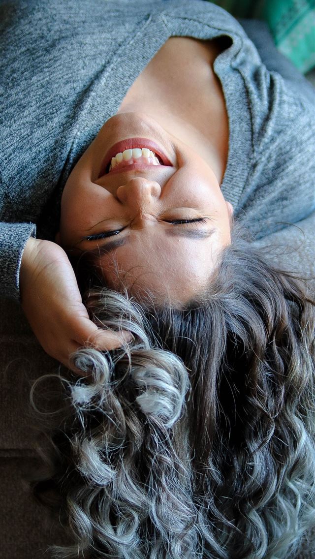 640x1136 woman laying on couch near throw pillow -  iPhone Wallpaper