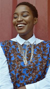 woman smiling beside red wall wallpaper