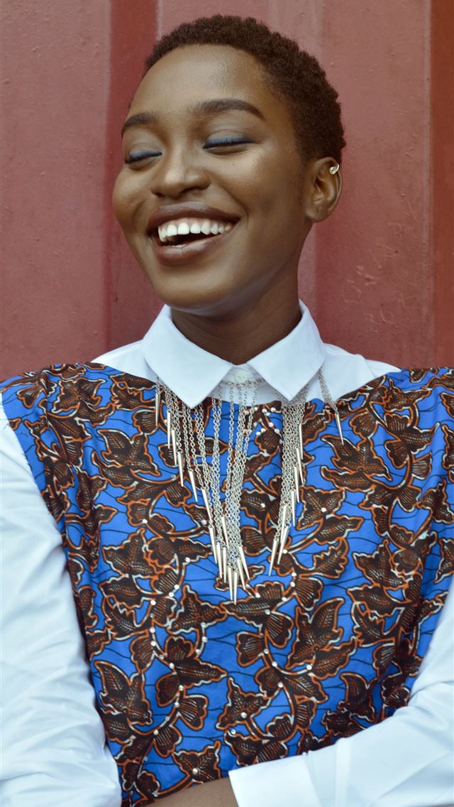 640x1136 woman smiling beside red wall - lagos iPhone Wallpaper