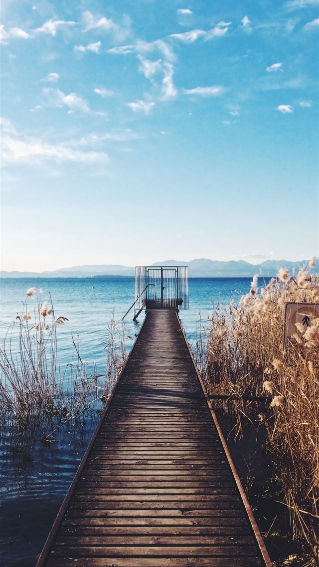 640x1136 photo of brown wooden boardwalk nearby sea - colorful iPhone Wallpaper