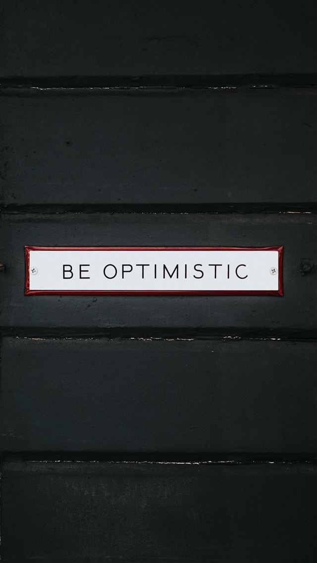 black wooden door with be optimistic text overlay iPhone wallpaper 