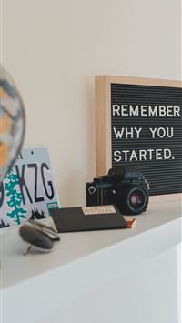 shallow focus photo of black SLR camera on white w... wallpaper