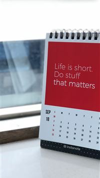 spiral freestanding calendar on white surface wallpaper