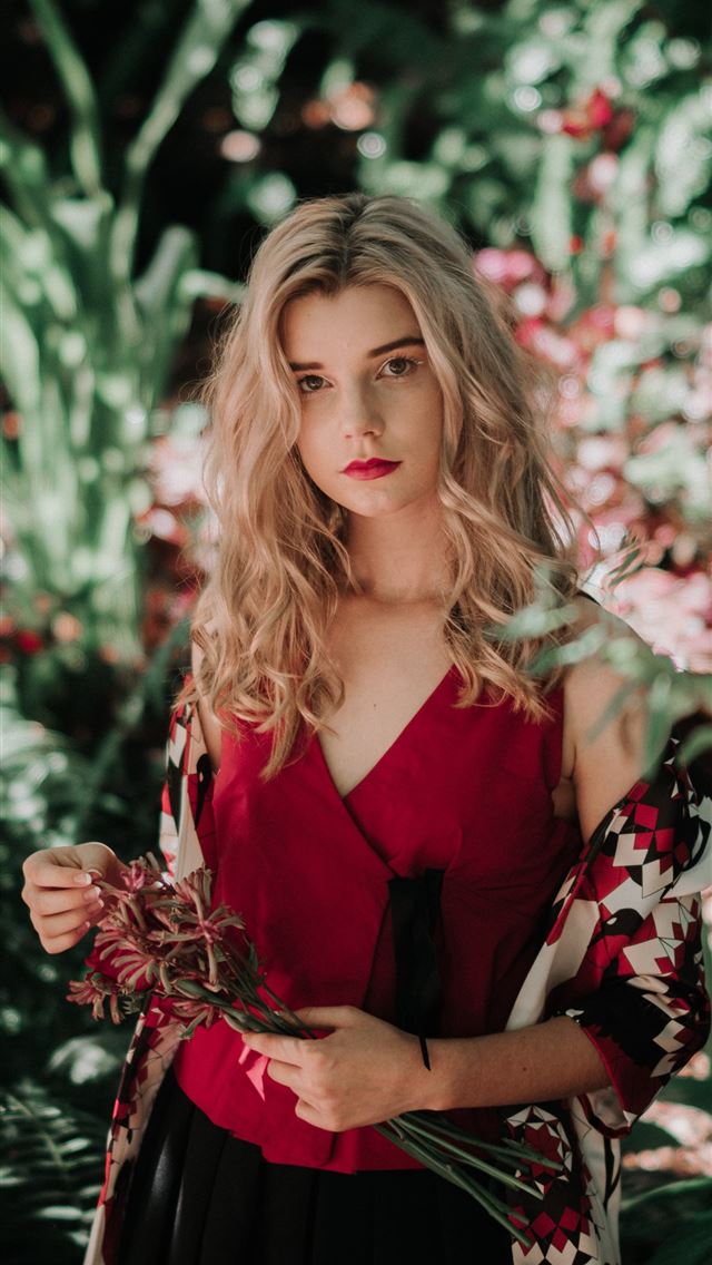 640x1136 woman holding flowers in front of the garden - beautiful iPhone Wallpaper