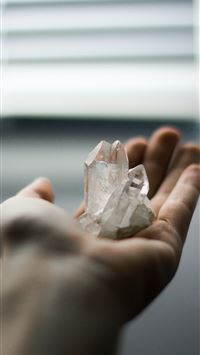 person holding crystal stones wallpaper