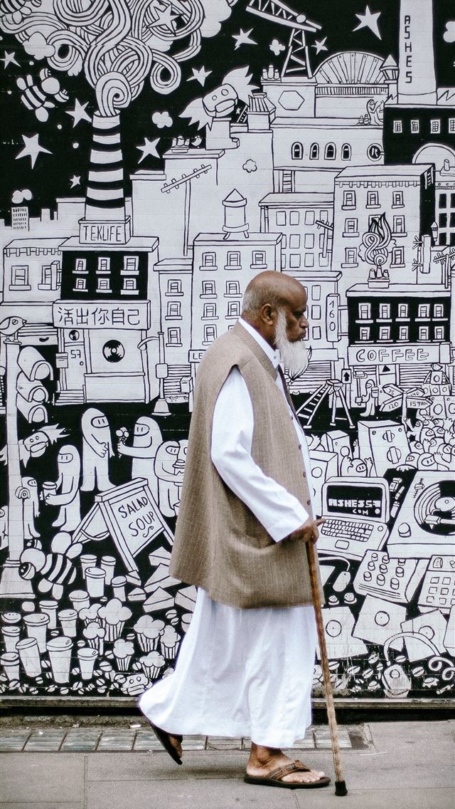 640x1136 man wearing white sherwani robe beside graffiti - london iPhone Wallpaper