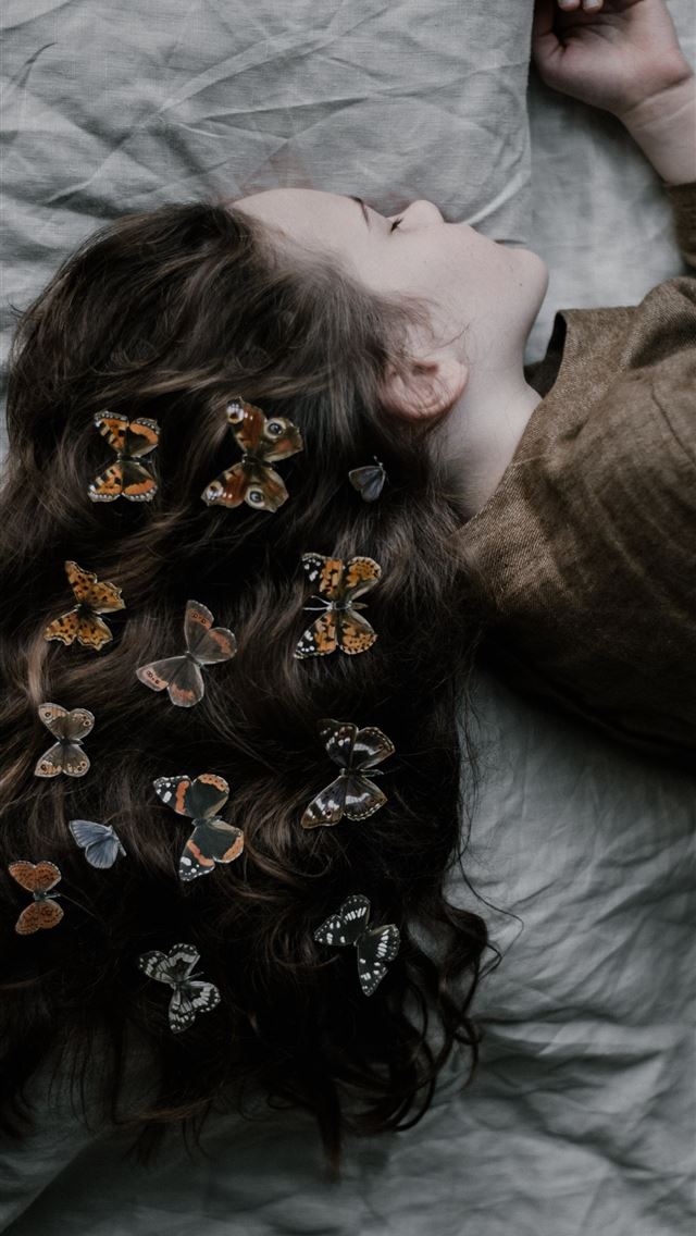 640x1136 girl lying on gray bed sheet - butterfly iPhone Wallpaper