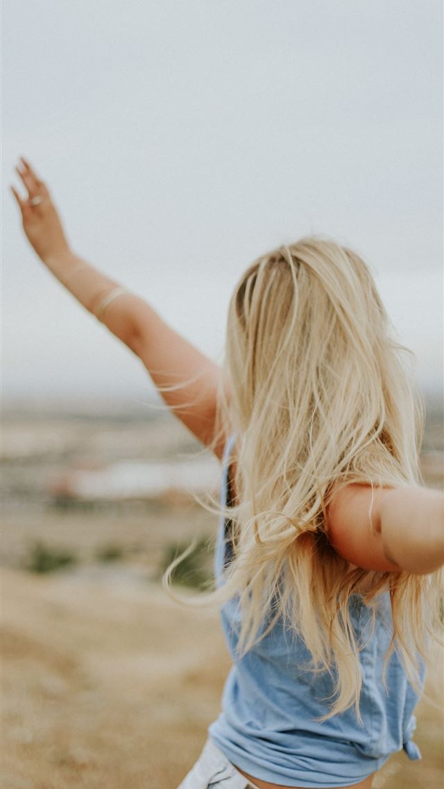 640x1136 woman wearing blue top while standing on plain fie... - girls iPhone Wallpaper