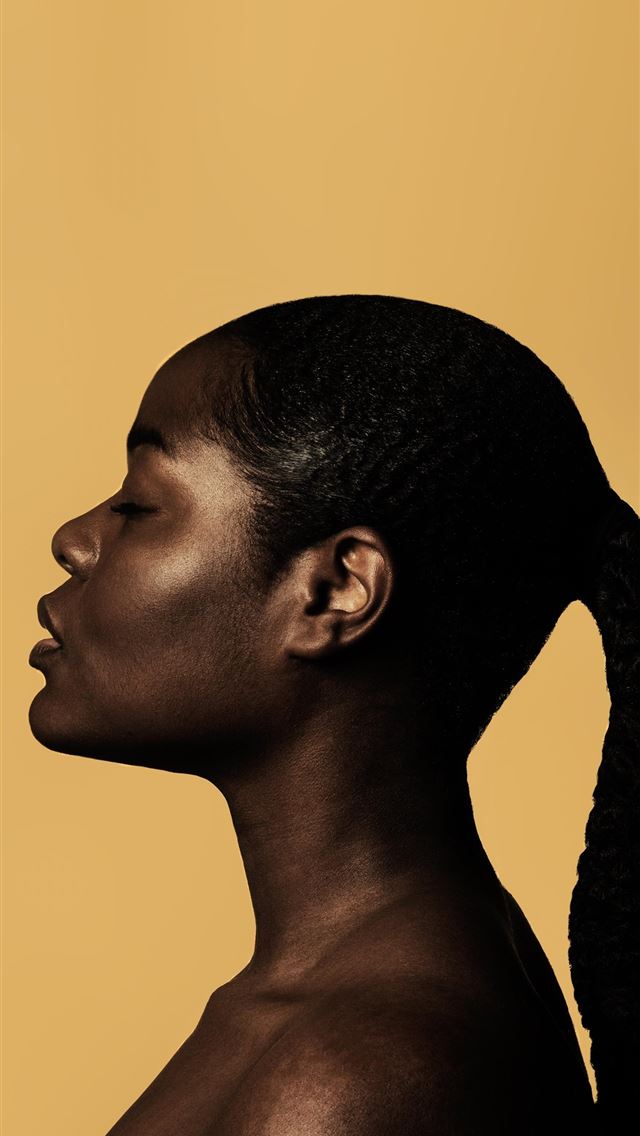 640x1136 braided woman taking photo beside yellow painted w... - united states iPhone Wallpaper