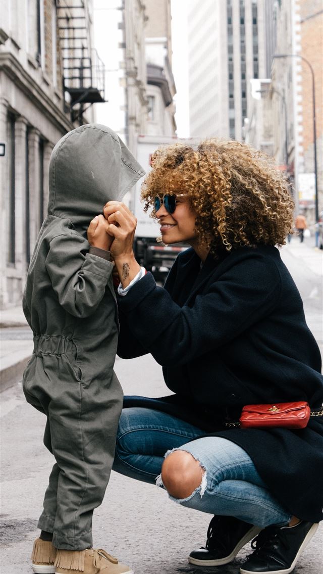640x1136 woman holding kid at the street - canada iPhone Wallpaper