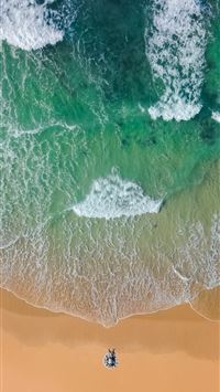 top view photography of brown sand on beach with t... wallpaper