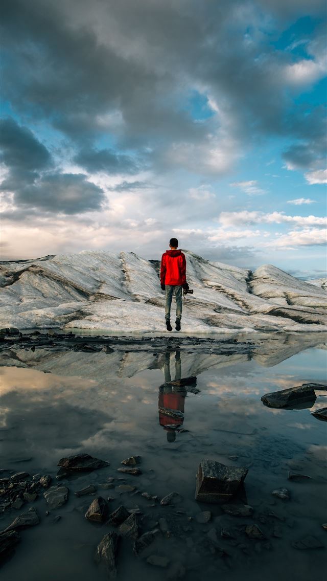 640x1136 man standing near body of water of water - stone iPhone Wallpaper