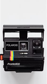black Polaroid camera with white background wallpaper