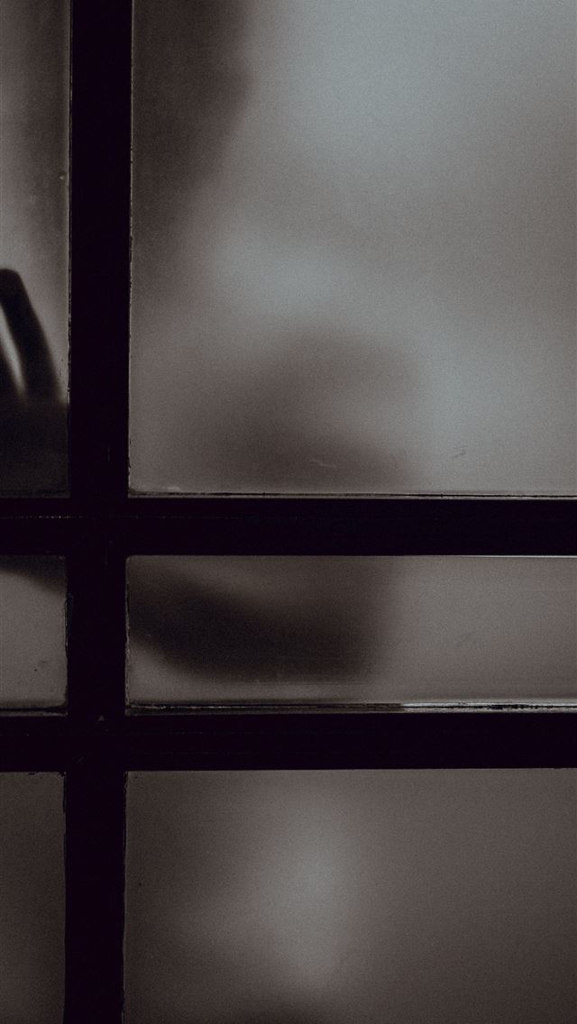 640x1136 person touching frosted glass door - dark (black) iPhone Wallpaper