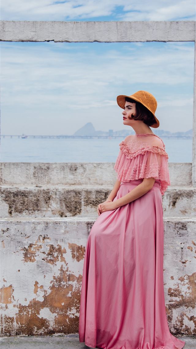 640x1136 woman wearing pink dress standing next to white wa... - vintage iPhone Wallpaper