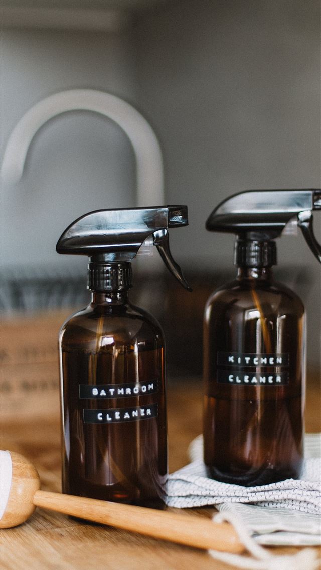 640x1136 two brown spray bottles on brown table - latvia iPhone Wallpaper
