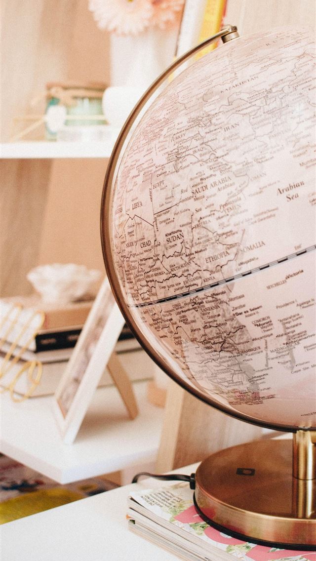 640x1136 white and black desk globe on the top of magazines - website iPhone Wallpaper