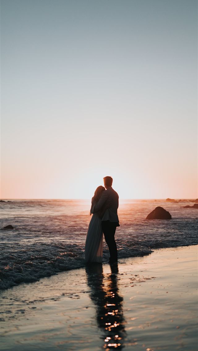640x1136 silhouette photo of couple standing on beach watch... - love iPhone Wallpaper