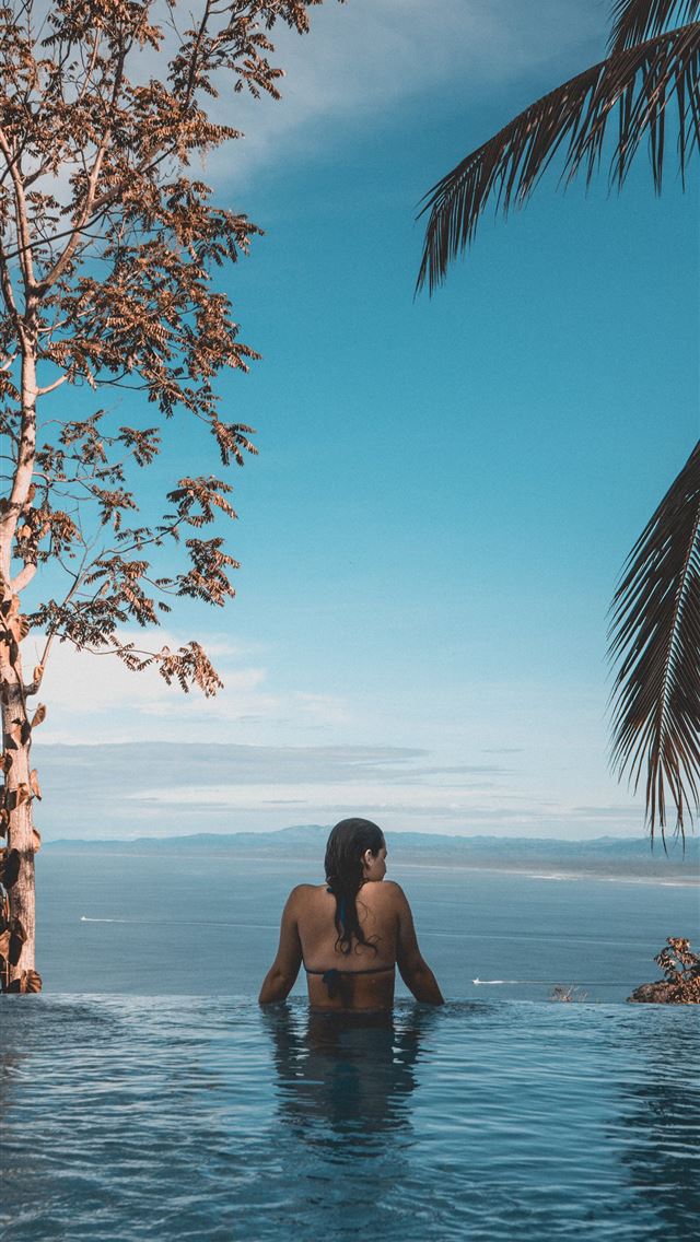 640x1136 woman wearing black bikini tap swimming on body of... - costa rica iPhone Wallpaper