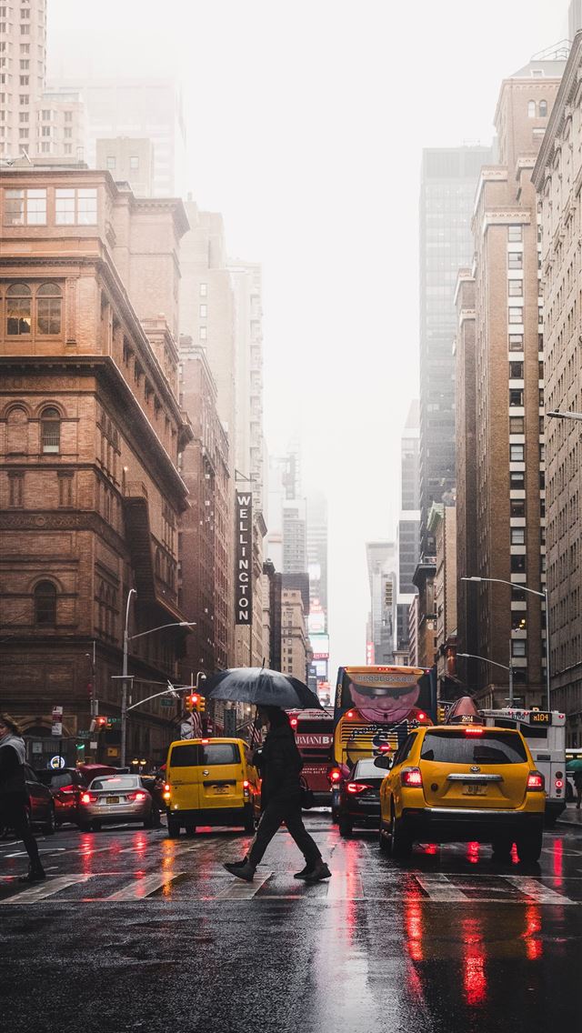 640x1136 person walking on pedestrian lane between building... - yellow iPhone Wallpaper