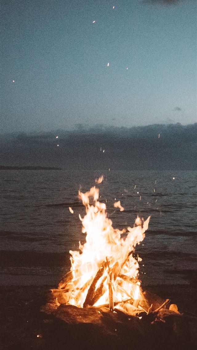 1284x2778 bonfire near seashore during nighttime - yellow iPhone Wallpaper
