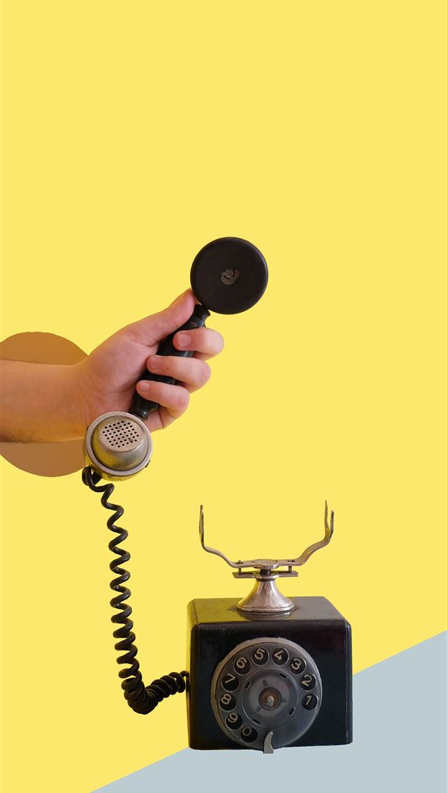 1284x2778 person holding black rotary telephone - yellow iPhone Wallpaper