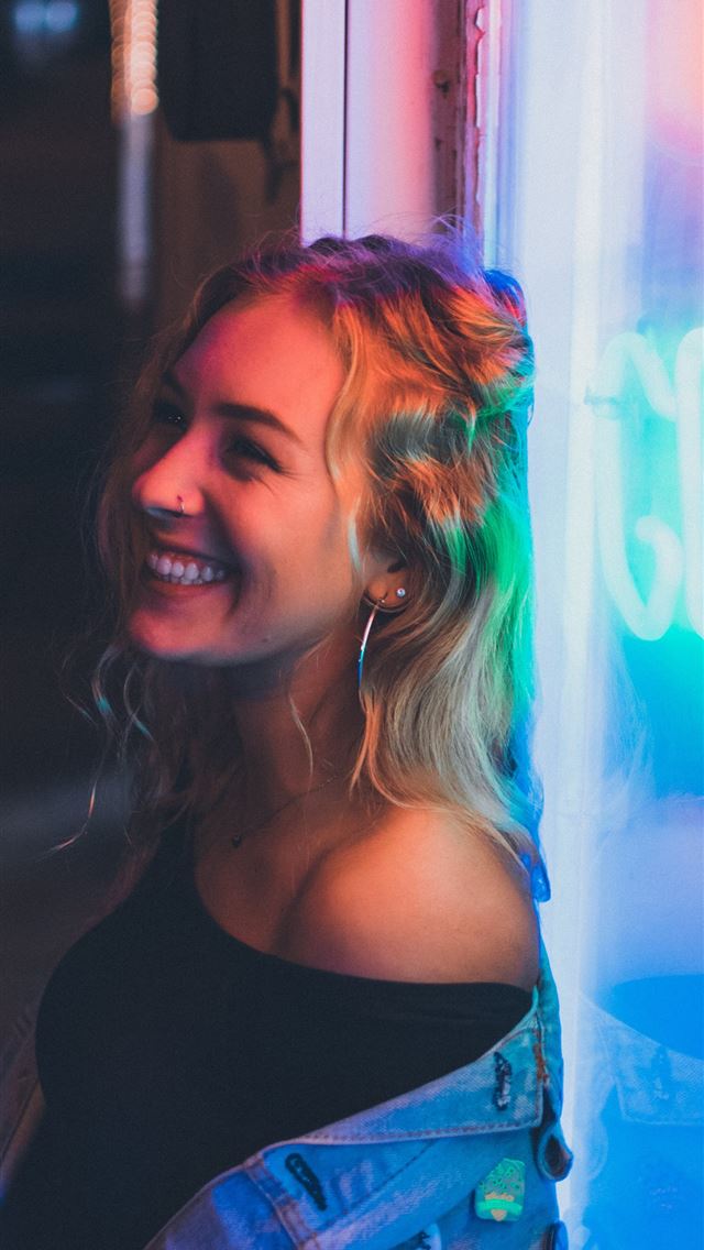 1284x2778 woman leaning on neon signage - girl iPhone Wallpaper