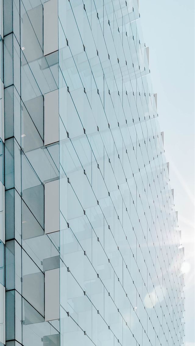 1284x2778 glass panel high rise building under blue sky with... - spain iPhone Wallpaper