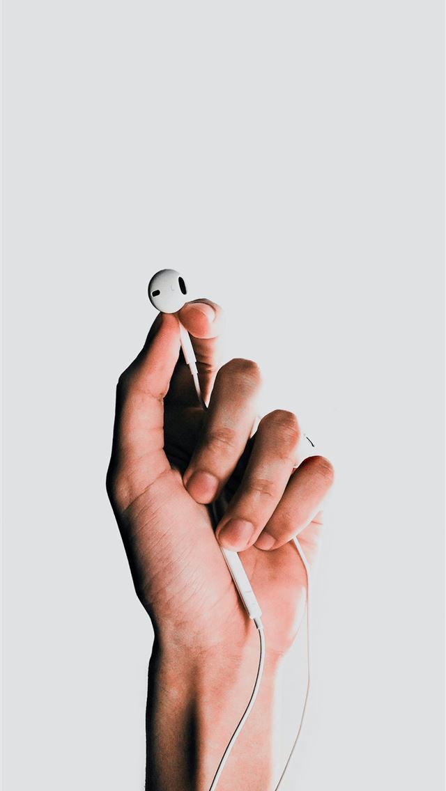 1284x2778 person holding Apple EarPods - music iPhone Wallpaper