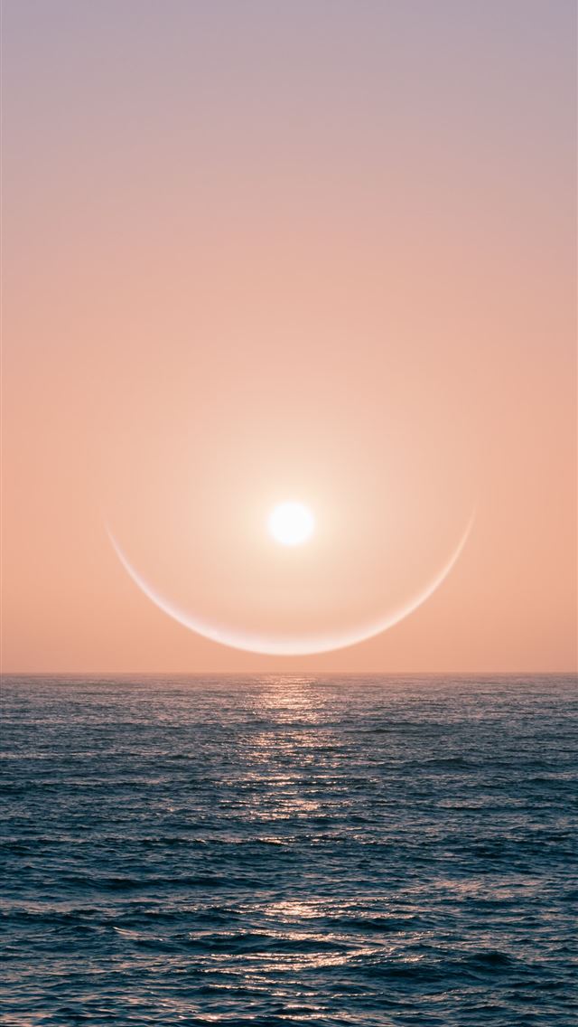 1284x2778 sun over the sea during sunset - portugal iPhone Wallpaper