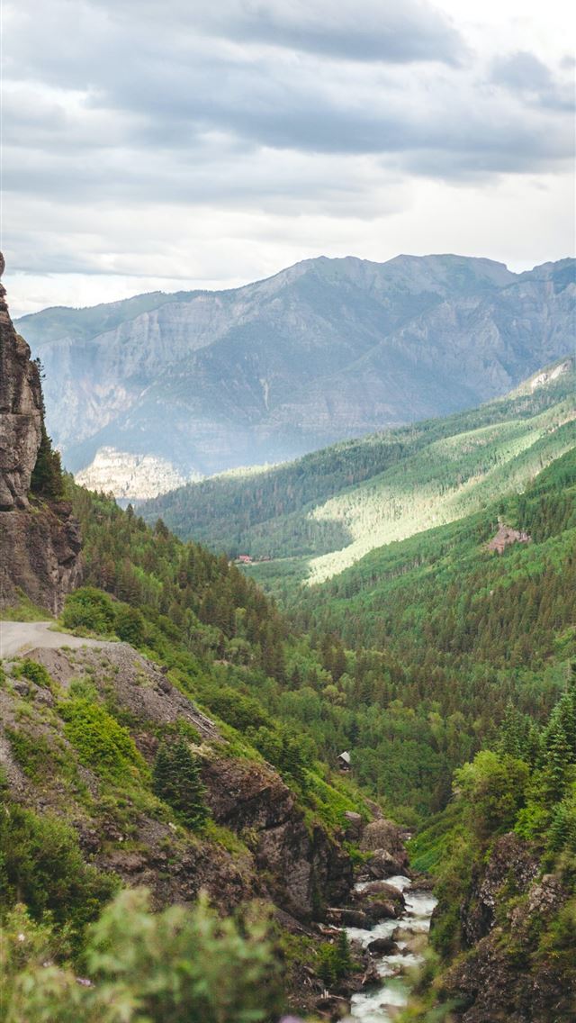 1284x2778 green plants surround brown cliffs during daytime - colorado iPhone Wallpaper