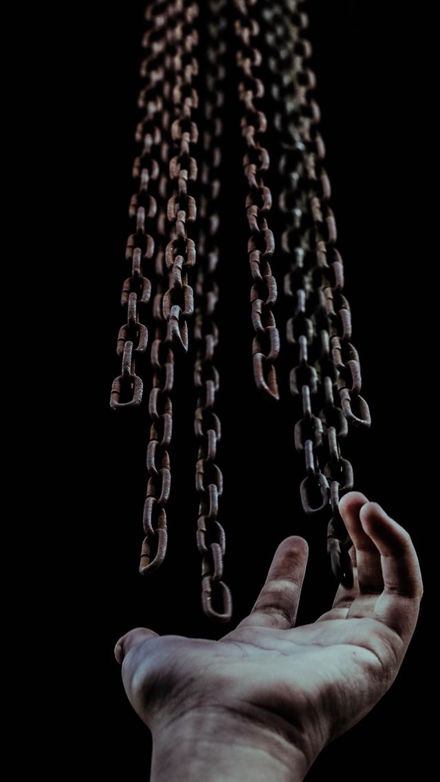 1284x2778 man's hand and chains - venezuela iPhone Wallpaper