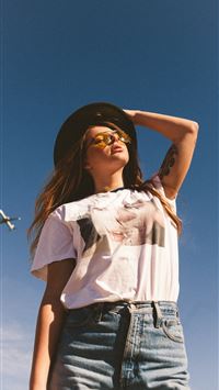 woman holding her black hat wallpaper