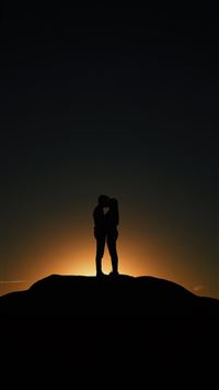 man and woman kissing wallpaper